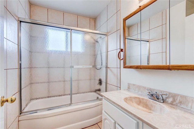 bathroom with vanity and combined bath / shower with glass door