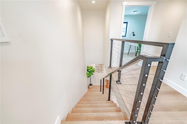 stairs featuring hardwood / wood-style flooring