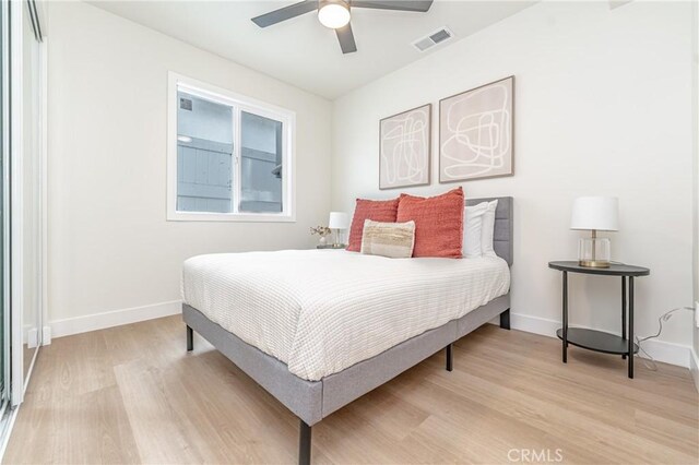 bedroom with ceiling fan and light hardwood / wood-style floors