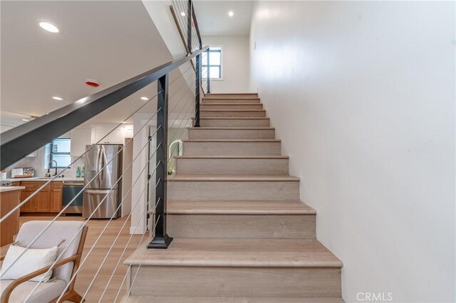 stairway featuring sink