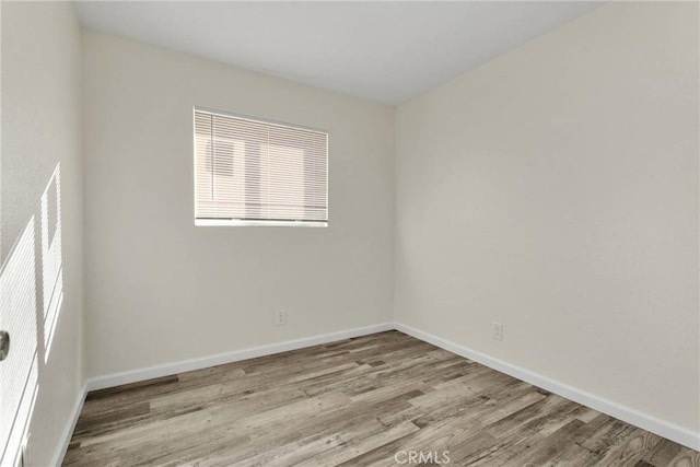 spare room with light hardwood / wood-style flooring