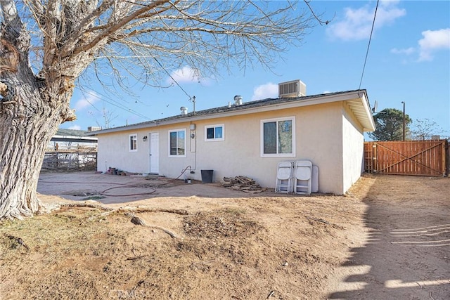 rear view of property featuring a patio area and central air condition unit