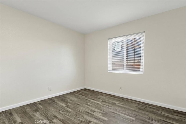 spare room with dark hardwood / wood-style floors