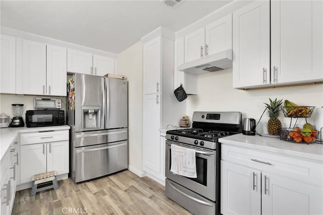 kitchen with white cabinetry, appliances with stainless steel finishes, and light hardwood / wood-style flooring