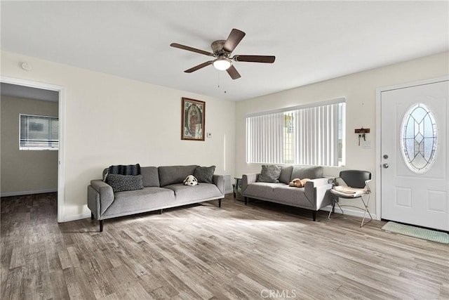 living room featuring ceiling fan and light hardwood / wood-style flooring