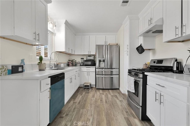 kitchen with sink, light hardwood / wood-style flooring, stainless steel appliances, and white cabinets