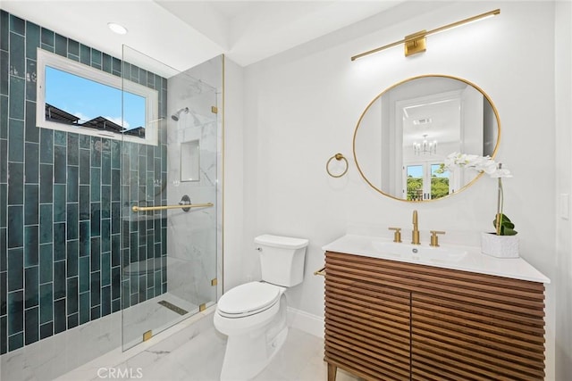 bathroom featuring toilet, a shower with door, and vanity