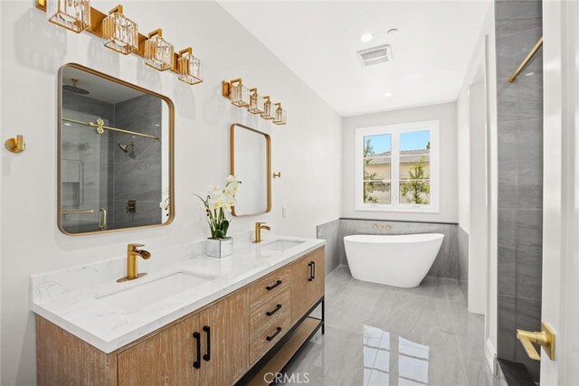 bathroom featuring tile walls, separate shower and tub, and vanity