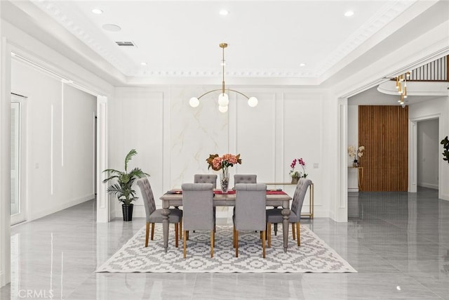 dining area featuring a raised ceiling and crown molding