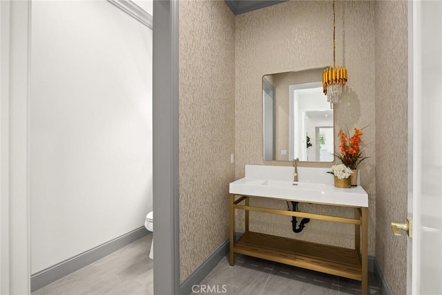 bathroom featuring toilet, tile patterned flooring, and sink