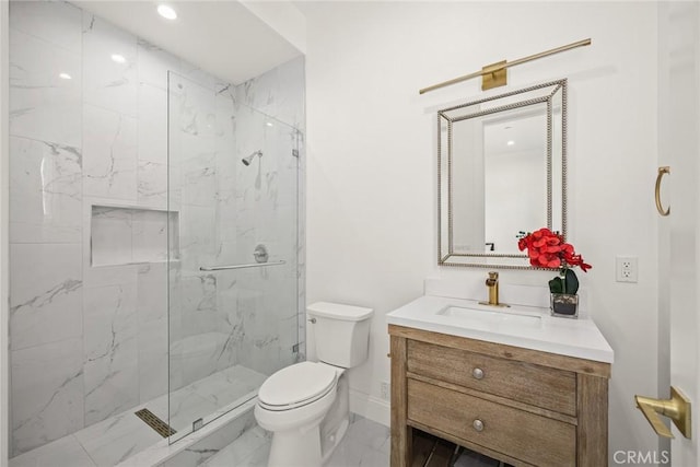 bathroom with toilet, vanity, and an enclosed shower