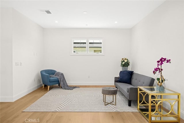 living area with hardwood / wood-style flooring