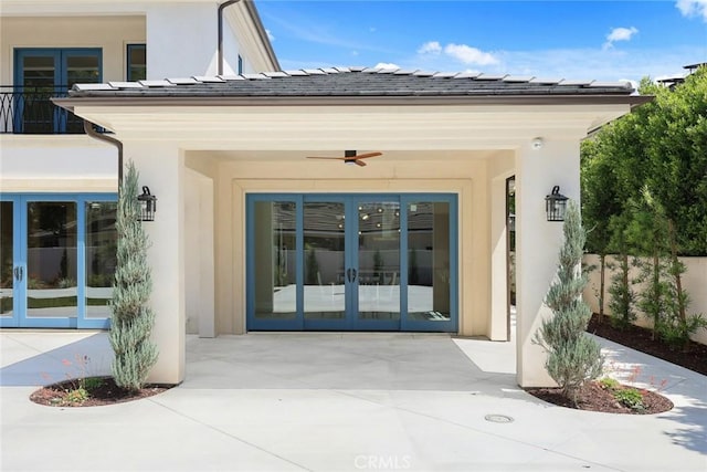 doorway to property featuring ceiling fan, french doors, and a patio