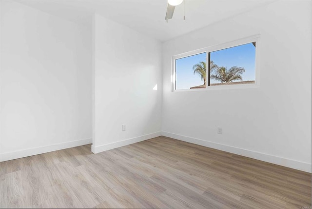 empty room with ceiling fan and light hardwood / wood-style flooring