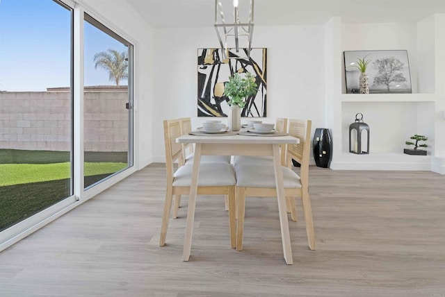 dining area featuring a chandelier and light hardwood / wood-style flooring