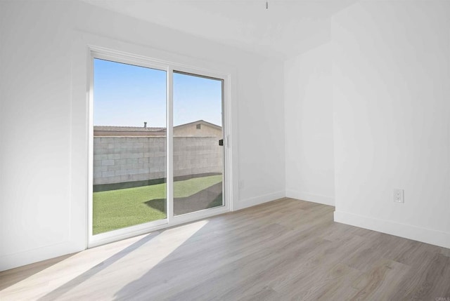 spare room with light hardwood / wood-style flooring