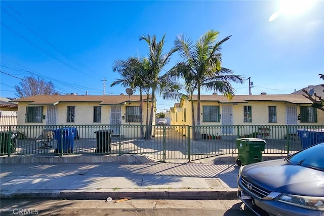 view of front facade with a fenced front yard and stucco siding