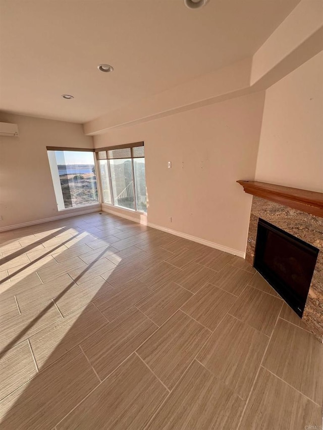 unfurnished living room featuring a wall mounted air conditioner