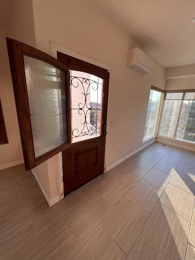 foyer entrance featuring a wall mounted air conditioner