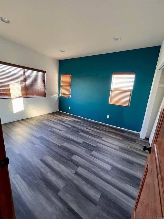 unfurnished bedroom featuring dark hardwood / wood-style flooring