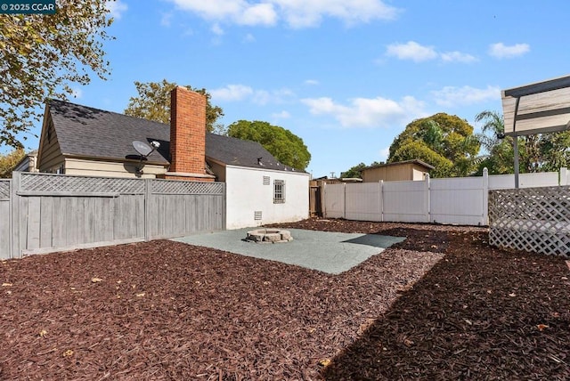 view of yard featuring a patio area and a fire pit