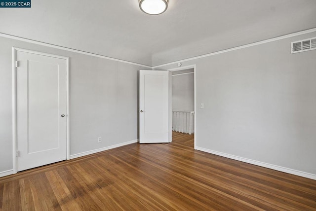 empty room with hardwood / wood-style flooring