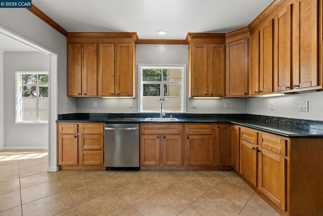 kitchen featuring stainless steel dishwasher, a wealth of natural light, sink, and light tile patterned floors