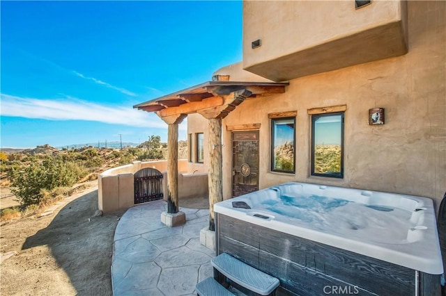 view of patio / terrace featuring a hot tub