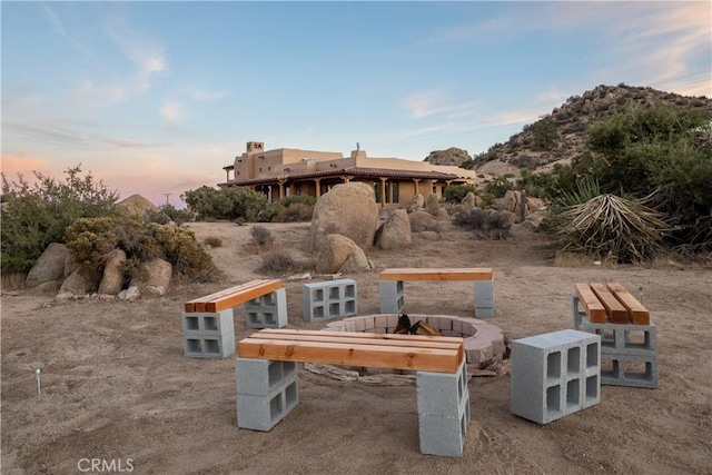 exterior space featuring an outdoor fire pit