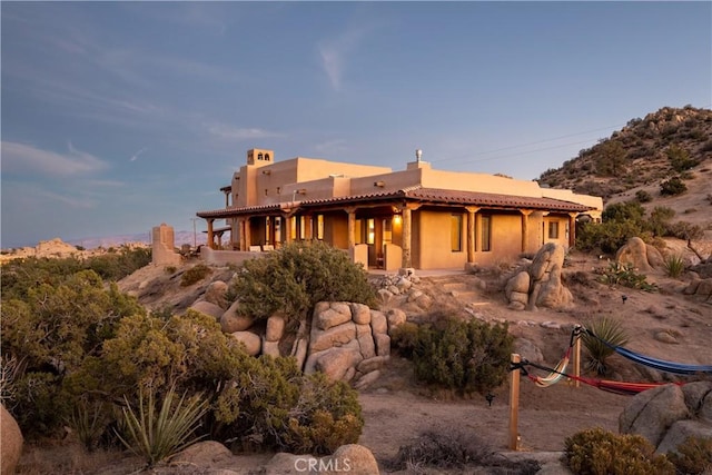 rear view of house featuring a mountain view