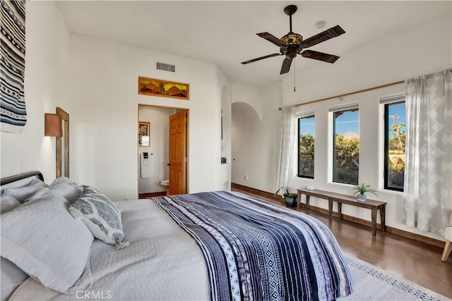 bedroom featuring ceiling fan, wood-type flooring, and ensuite bathroom