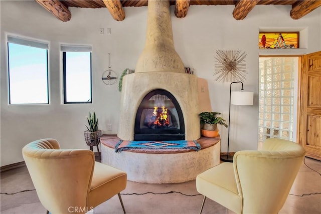 interior space featuring beam ceiling, a fireplace, and wooden ceiling