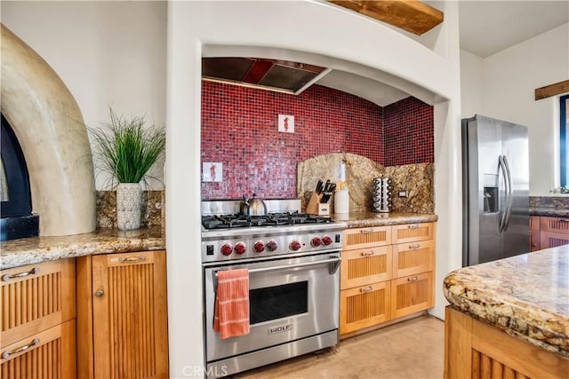 kitchen featuring light stone countertops, backsplash, and appliances with stainless steel finishes