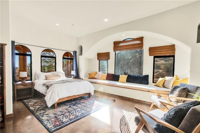 bedroom featuring concrete flooring