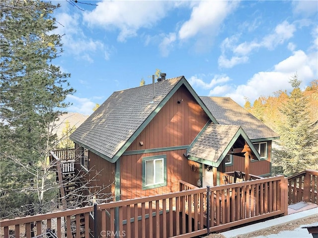 back of property with a wooden deck