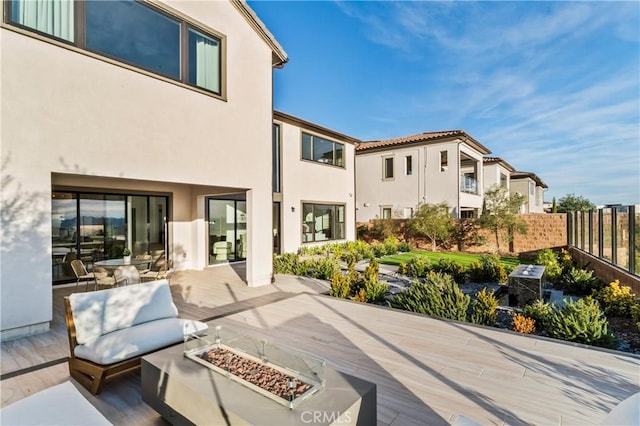 exterior space featuring an outdoor fire pit and a patio area