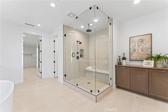 bathroom with plus walk in shower and tile patterned flooring