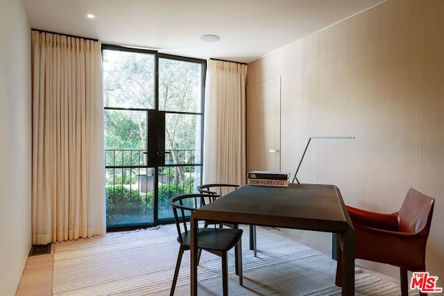 home office with floor to ceiling windows, plenty of natural light, and french doors