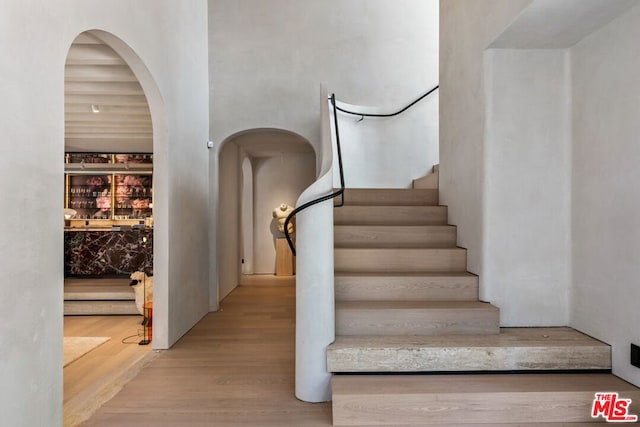 stairs featuring hardwood / wood-style flooring