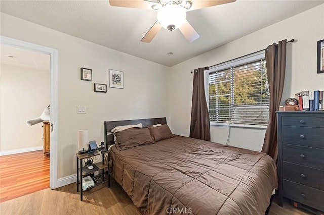 bedroom with ceiling fan and hardwood / wood-style flooring