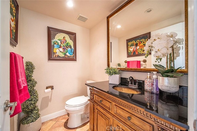 bathroom with toilet, tile patterned flooring, and vanity