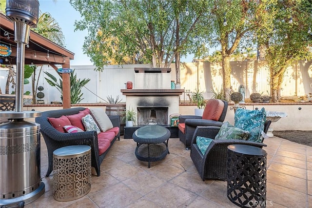 view of patio / terrace with an outdoor living space with a fireplace