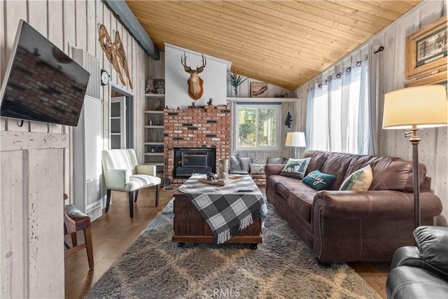 living room with lofted ceiling, hardwood / wood-style floors, wooden walls, built in shelves, and wooden ceiling