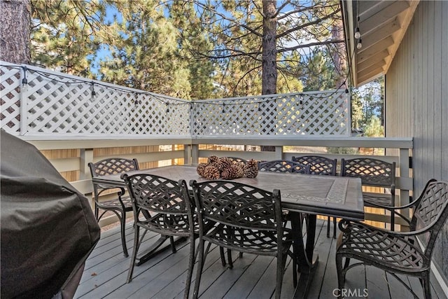 wooden deck featuring a grill