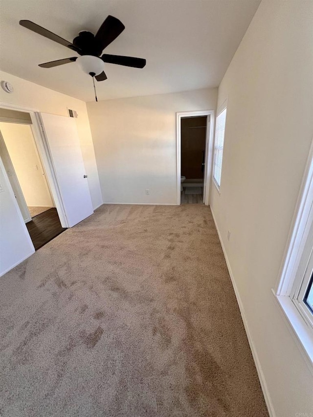 carpeted empty room with ceiling fan