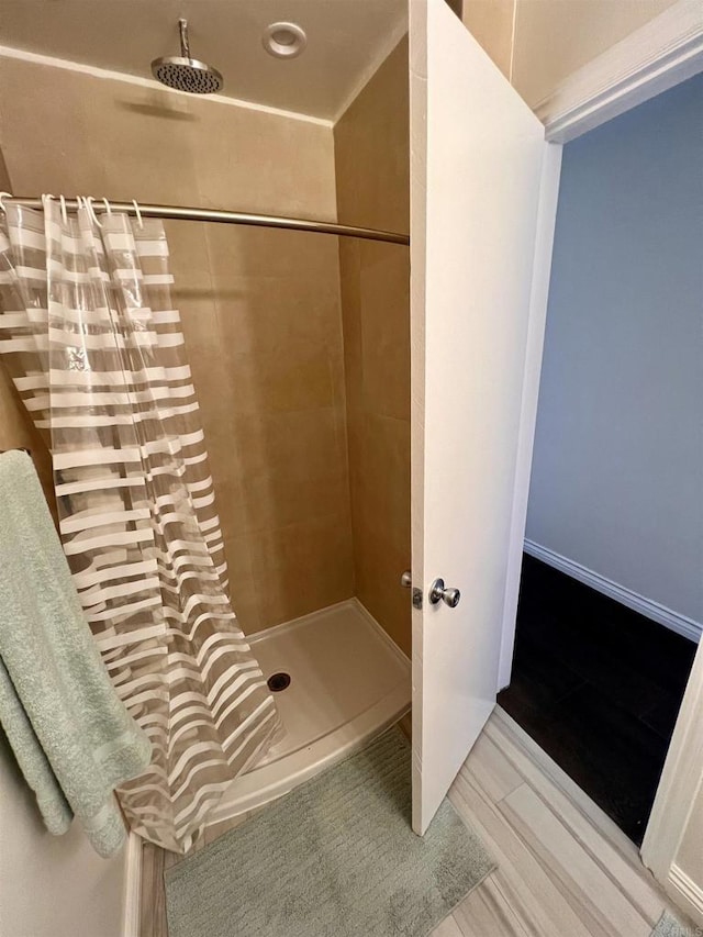 bathroom featuring a shower with curtain and hardwood / wood-style floors