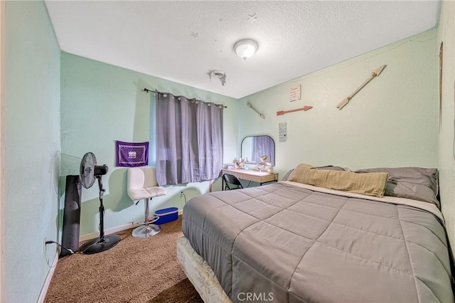 carpeted bedroom featuring a textured ceiling