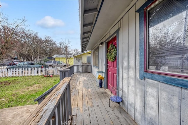 wooden deck featuring a lawn