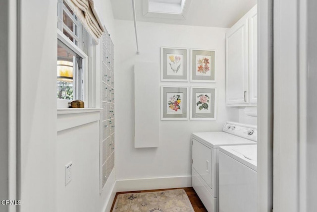 laundry area featuring washer and dryer, cabinets, and dark wood-type flooring