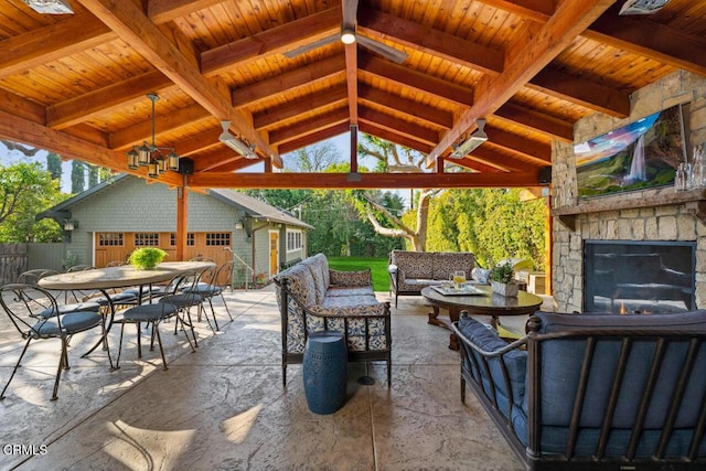 view of patio / terrace with an outbuilding, a gazebo, and an outdoor living space with a fireplace